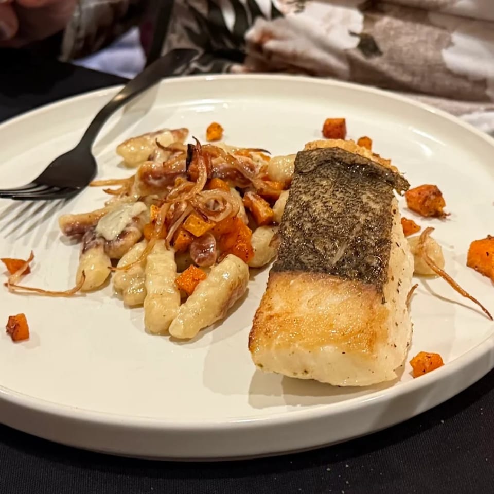 Astrid's southern-style fish with crispy skin, gnocchi, caramelized onions, and butternut squash.